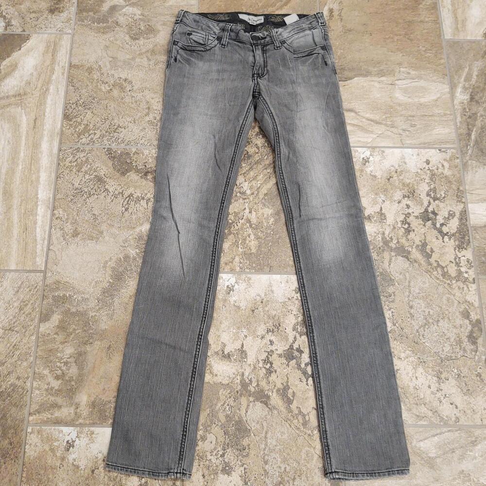 Light gray skinny jeans with sequin bedazzled skulls on back pockets